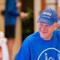 Two Alumni laughing at the breakfast.